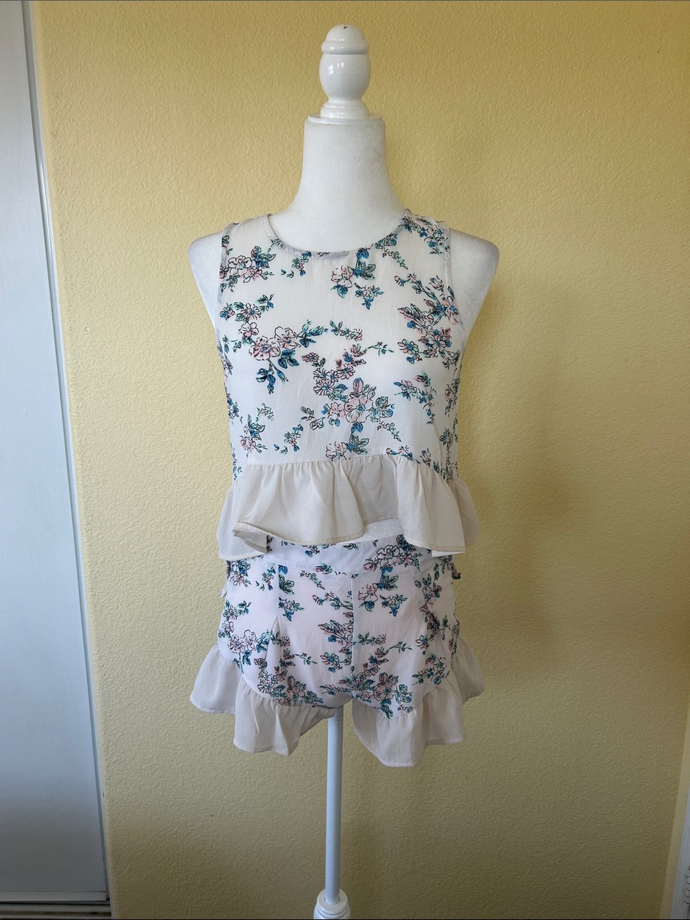 L'ATISTE Cream Floral Sleeveless Peplum Top with Pink & Teal Accents